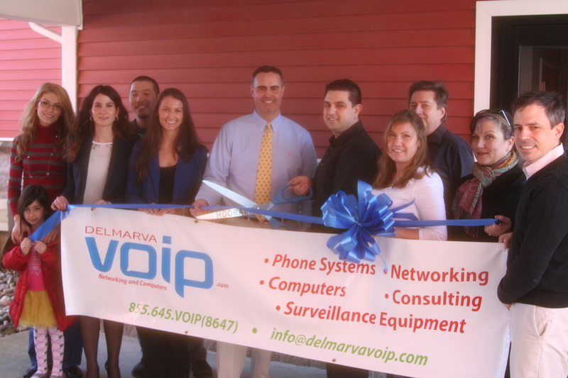 DelmarvaVOIP held a ribbon-cutting last month to celebrate opening the company’s office in Lewes. The company provides customized telephone systems for voice over internet protocol and other computer and information technology services. Shown are (l-r) Gracie and her mother Rozi Berberian; Leila Sechler; Uuganbut Altangerel; Casey Bradham; Sen. Ernie Lopez, R-Lewes; Jack Berberian, president-founder; Patti Burkentine and Bobbi Engel, Lewes Chamber of Commerce; and Tim Latham. Not shown, Drew Laroche, co-founder.